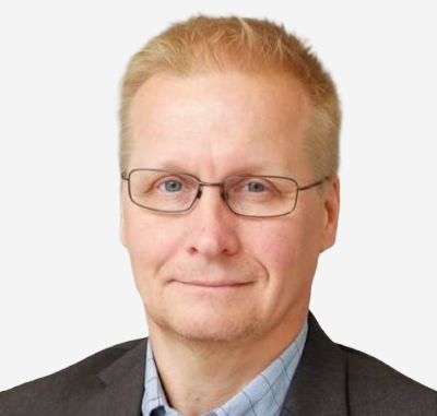 Arto Vilkman, Managing Director of Altum Vista, eye classes, blond hair, smiling in a dark suit and light blue shirt.